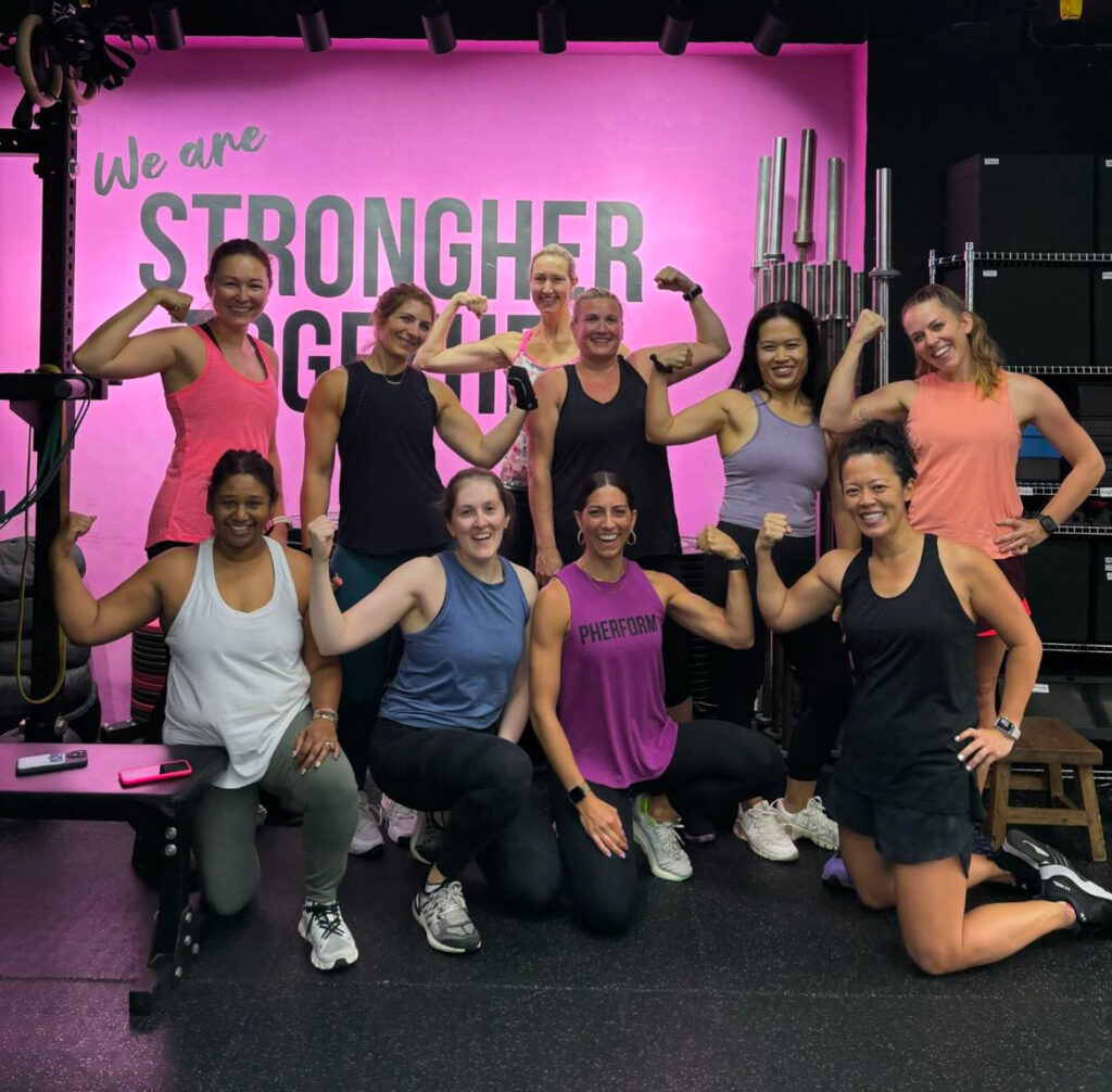 10 women posing at the gym after their workout